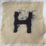 A piece of paper with the letter h on it.