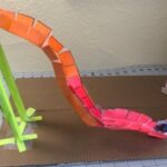 A toy roller coaster made of paper and cardboard.
