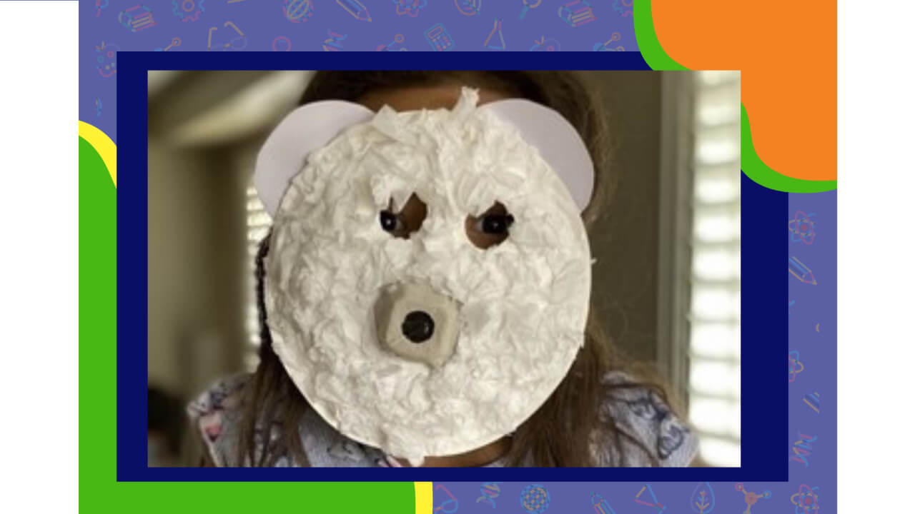 A girl with a paper plate bear mask.