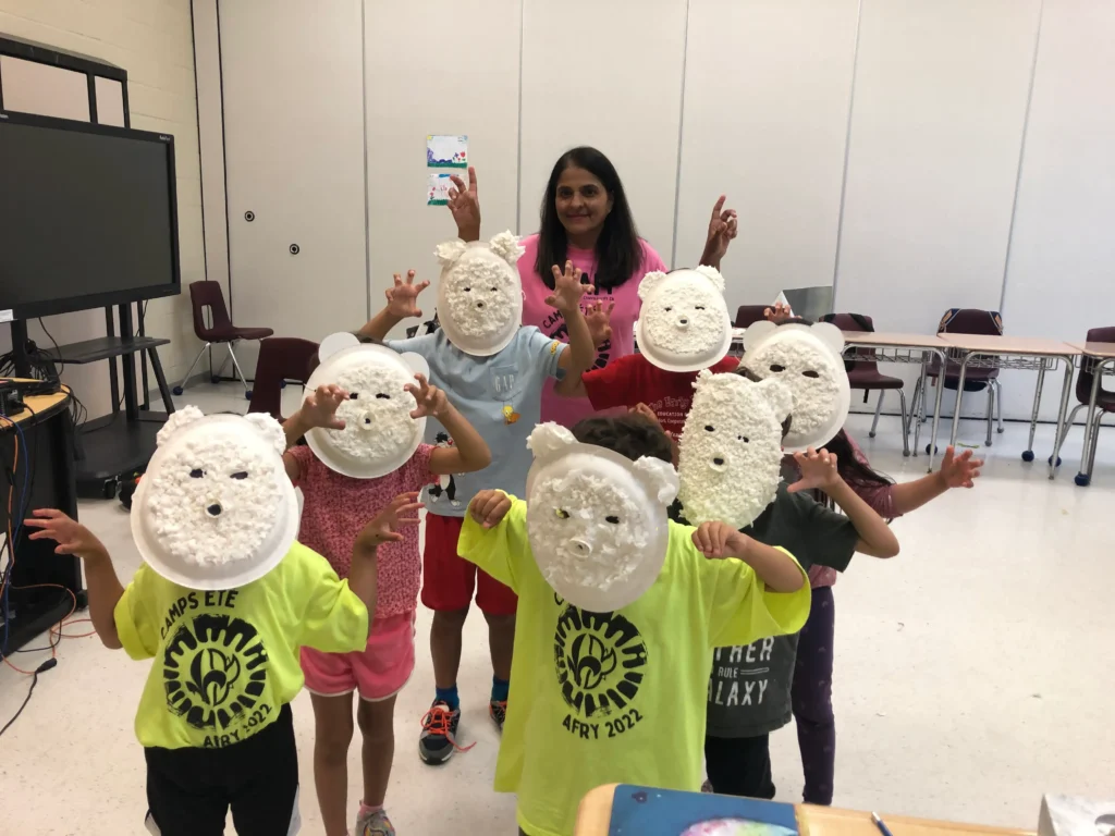 Picture of children wearing the polar bear masks they did at camp.