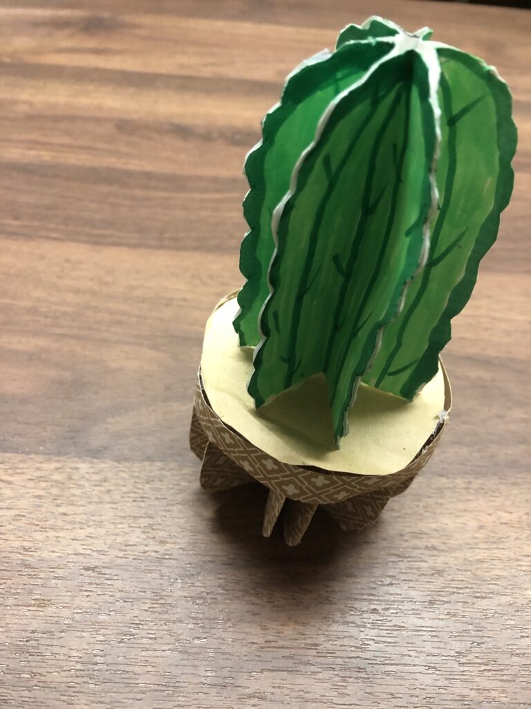 Paper folded and glued in the shape of a cactus