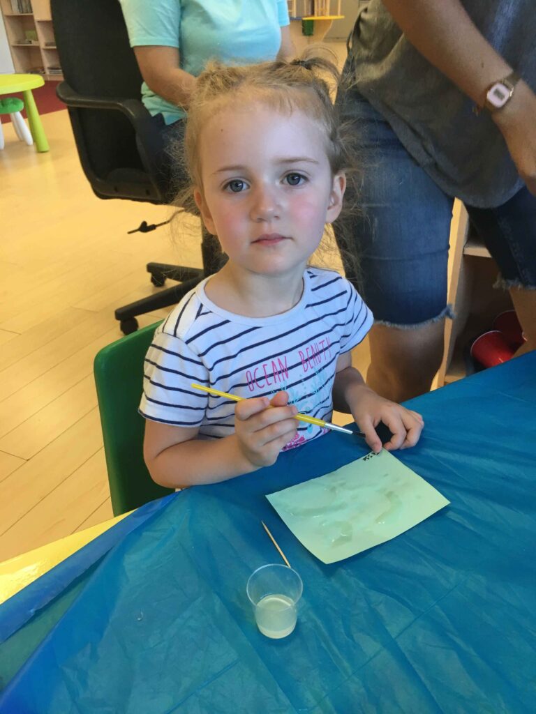 Girl writing a message in invisible ink