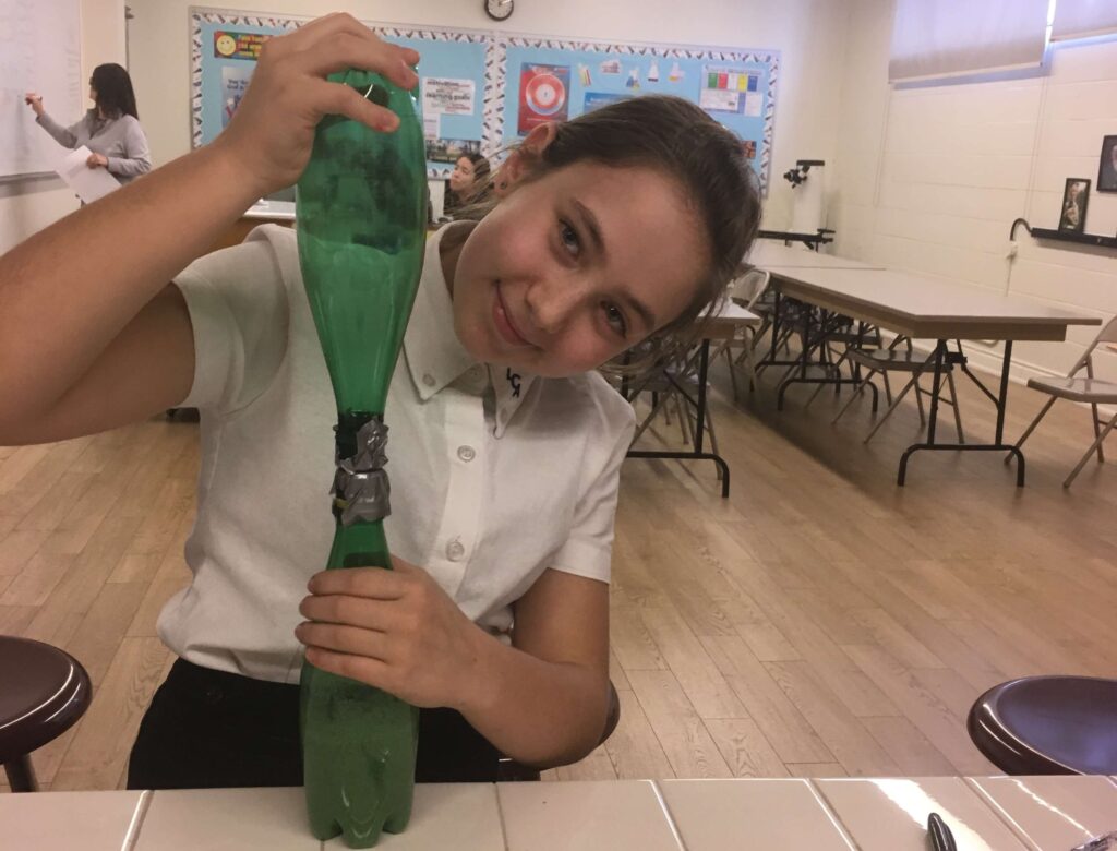 Girl holding the hourglass she made herself.