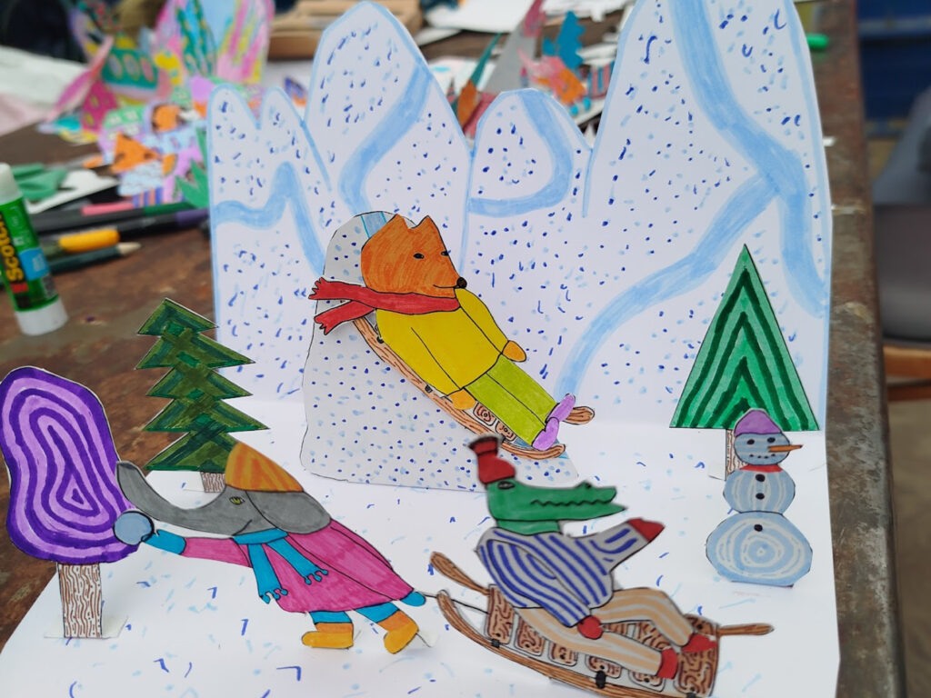 Drawing of animals going down a snow mountain in Pop Up Art