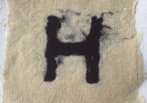 A piece of paper with the letter h on it.