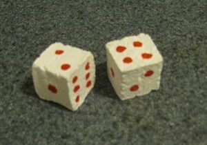 Two dice with red dots on them sitting next to each other.